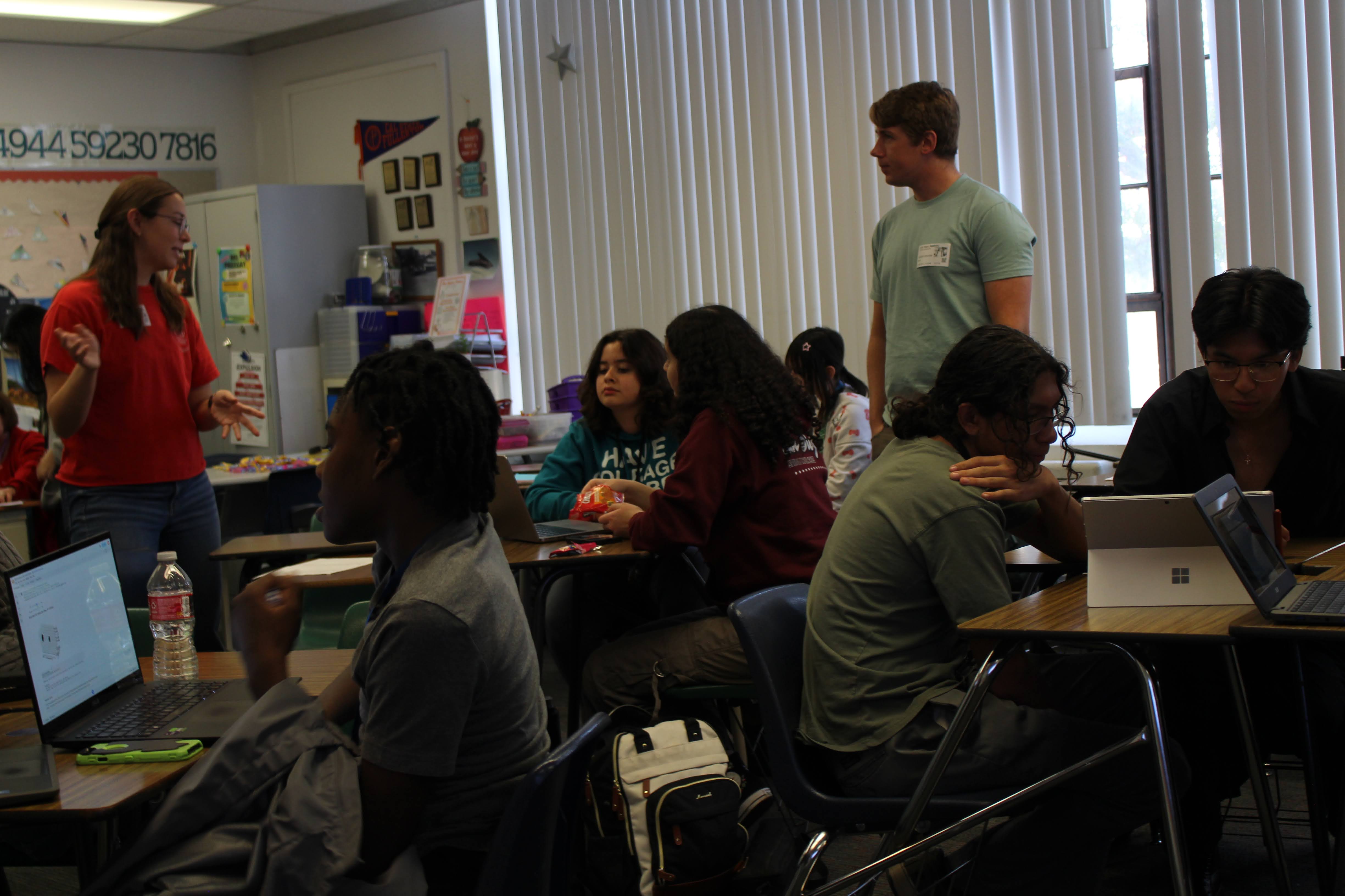 Volunteers Madeline Overton and Ted Johnson helping students