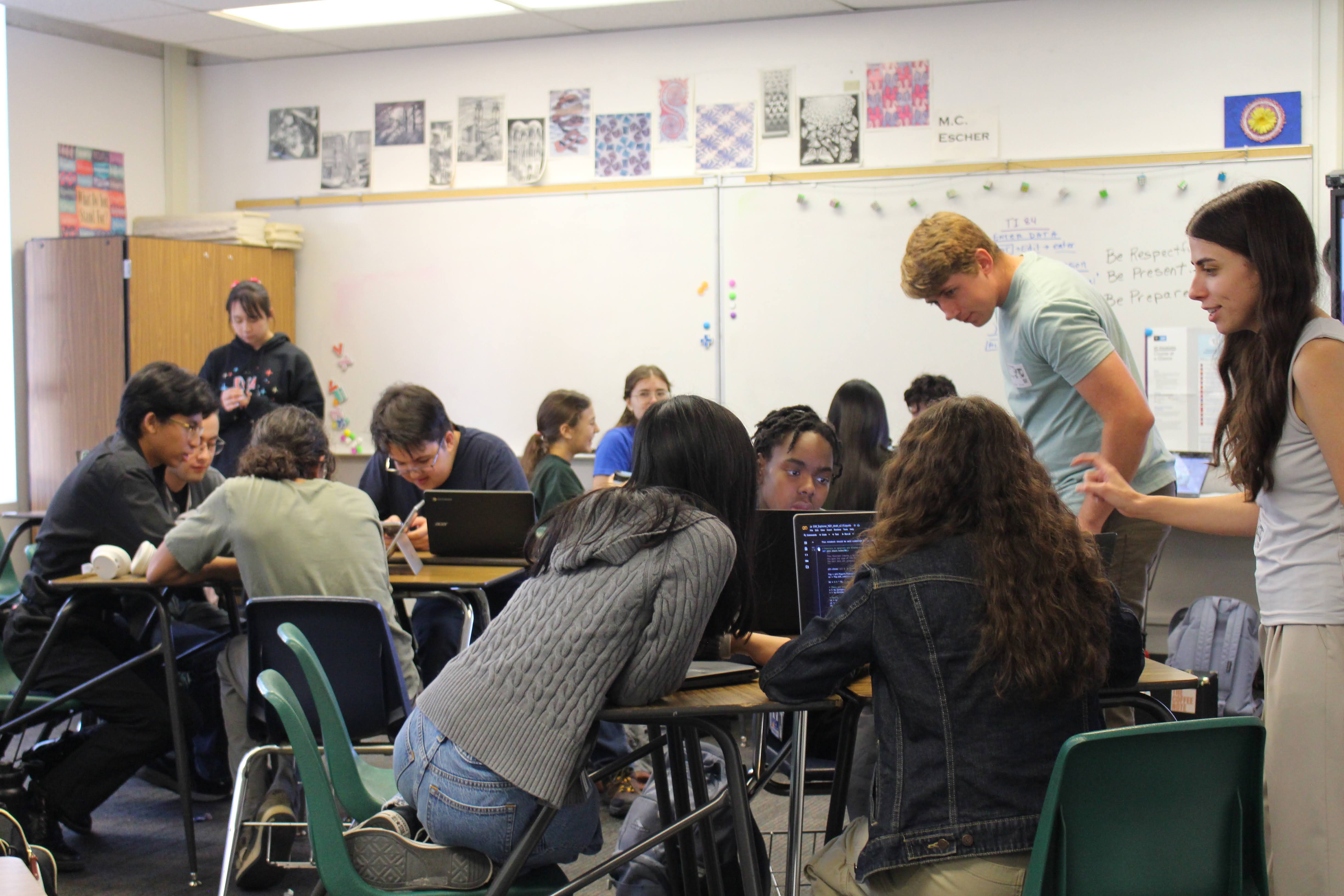 Volunteers Rachel Langgin and Ted Johnson helping students